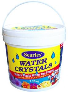 A 2.25 kg container of Searles Water Crystals is designed to water plants when needed and enhance plant growth. Perfect for your Corylus 'Crazy Filbert' in an 8" pot, the container is white with a yellow label and blue water droplet illustrations.