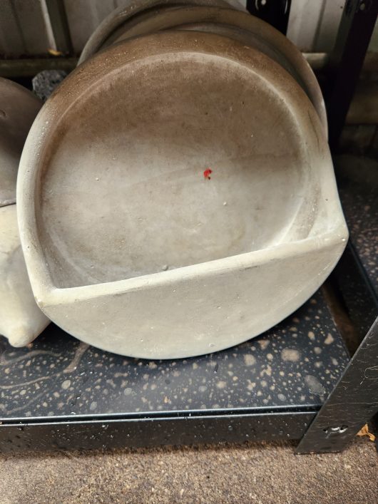 A set of Dart Wall Pot Cement 21x7cm bowls sitting on top of a metal rack.