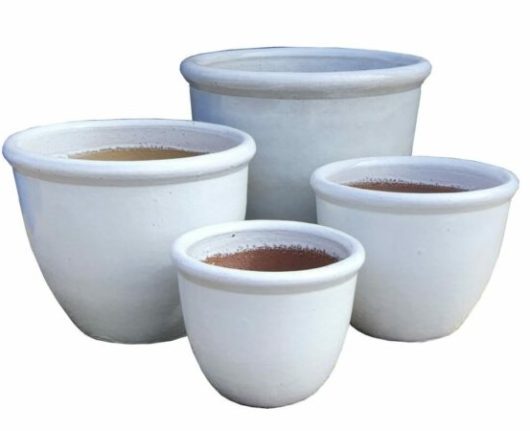 Four white ceramic pots decorative for gardens and plants
