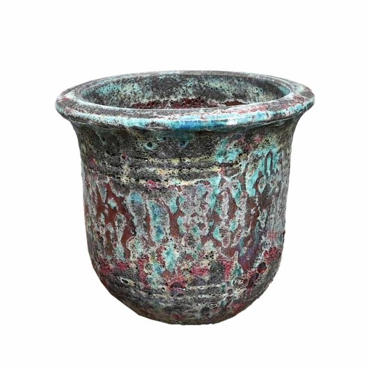 A weathered ceramic Seafoam Verona Planter Aqua 30x26cm, featuring a wide rim and a textured, multicolored surface with shades of green, blue, and reddish-brown.