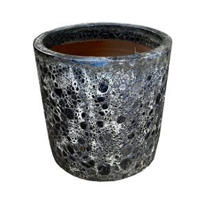 The speckled, cylindrical Seafoam Bermuda Planter Aqua S 30x20cm features a rough texture and dark interior, ideal for bringing a natural touch to any space.